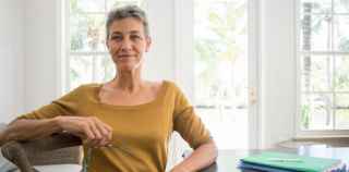 Image of mature woman holding glasses